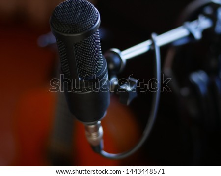 Professional Studio Microphone in recording studio on guitar background