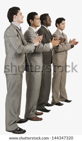 Four businessmen applauding