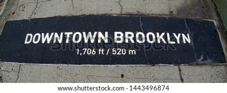 Signs on the ground indicating distances from the end of Brooklyn Bridge, New York, USA