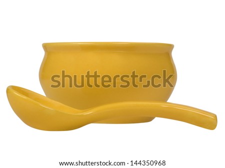 Close-up of a ceramic bowl with a soup spoon
