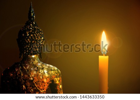 Candlelight shining bright gold behind the Buddha, the president of Buddhism, vintage background images.