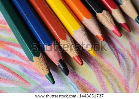 Colored pencils a macro view, objects for creativity a large view on the background of the drawing drawn by them