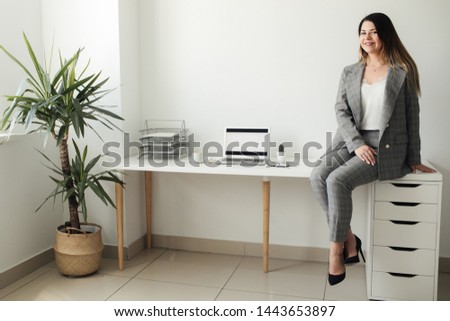 younger girl working in the office at the table