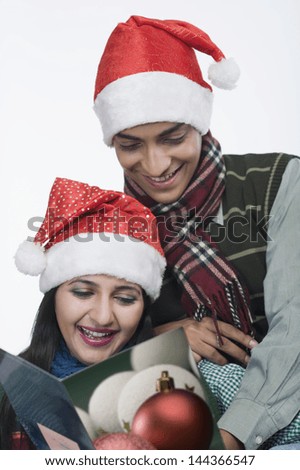 Couple reading a greeting card and smiling