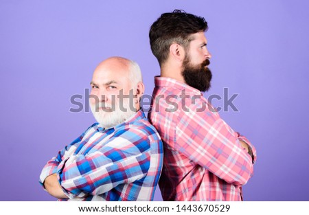 Brutal guys with long beard. Bearded friends. Hairdresser salon. Barbershop concept. Barber well groomed handsome bearded man. Father and son. Men bearded hipster stand back to back. Family team.