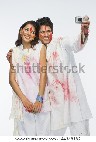 Couple taking a picture of themselves on Holi