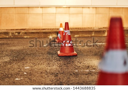 bright orange traffic cones standing in a parking
