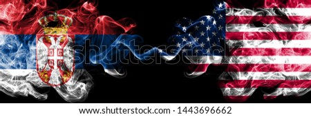 Serbia vs United States of America, American smoky mystic flags placed side by side. Thick colored silky smokes combination of Serbian and United States of America, American flag