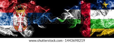Serbia vs Central African Republic smoky mystic flags placed side by side. Thick colored silky smokes combination of Serbian and Central African Republic flag
