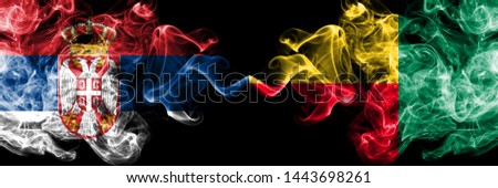 Serbia vs Benin, Beninese smoky mystic flags placed side by side. Thick colored silky smokes combination of Serbian and Benin, Beninese flag