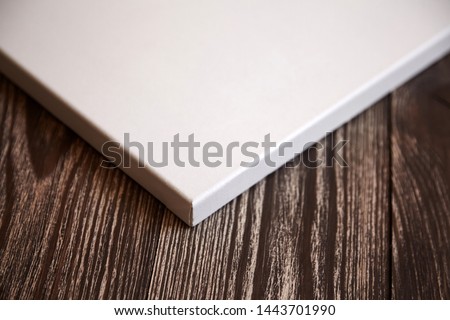 Artistic white blank cotton canvas on brown wooden background. Mockup