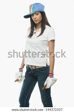 Portrait of a female cricket fan holding bails