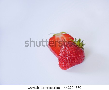 Strawberries are sliced ​​in pieces on a gray background