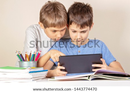 Kids using together tablet computer at home