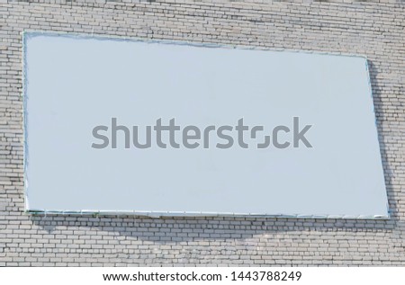 Large advertising banner on a brick wall