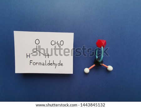 Molecular structure model and structural chemical formula of formaldehyde molecule.  Formaldehyde (methanal) is an organic compound; it is the simplest of the aldehydes. Black=C, white=H, red=O. Royalty-Free Stock Photo #1443845132