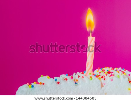 Candle on rainbow cake