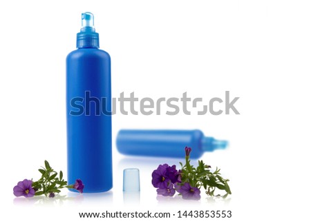 generic blue plastic hair product or skin care spray bottle with pump sprayer with purple flowers on white