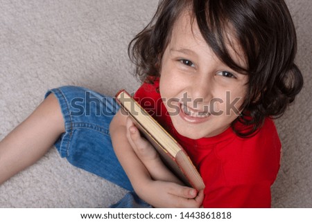 Little boy with book hand  as education and studying concept