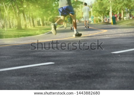 Blurry image of people in exercise by running  To maintain health in the morning  In the atmosphere of sunlight and fresh air
