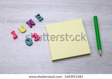 June 3 - Daily colorful Calendar with Block Notes and Pencil on wood table background, empty space for your text or design 