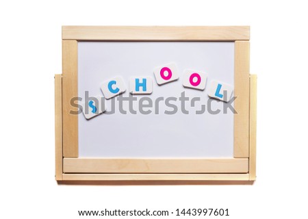 The inscription school is laid out on a white magnetic board. Back to school.
