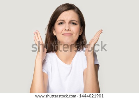 Millennial woman expressing disappointment asking for forgiveness apology sorry. Young teen female headshot, throw up hands as sign of inability, failure, mistake, regret isolated on grey background Royalty-Free Stock Photo #1444021901