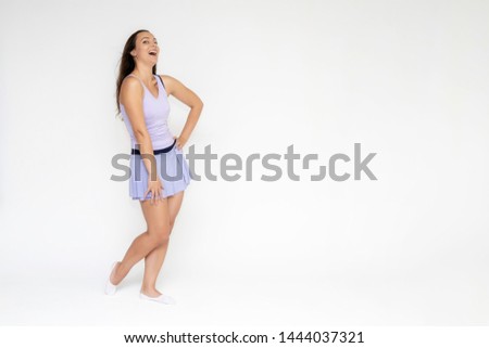 Full-length portrait on white background of beautiful pretty fitness girl woman in trendy tennis sport uniform, with different emotions in different poses, shows hands. Smiles. Stylish trendy youth.