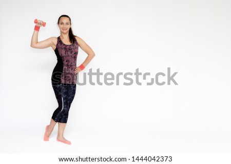 Full-length portrait on white background of beautiful pretty fitness woman girl in fashionable sportswear standing exercising in various poses with dumbbell. Smiles Stylish trendy youth.