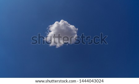white clouds float across the blue sky