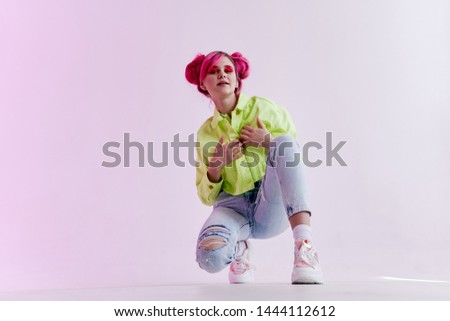woman with pink hair sat in jeans fashion style