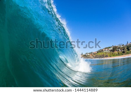 Ocean swimming closeup hollow crashing wave of blue water on beach sandbar cove scenic coast landscape.