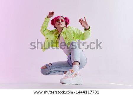 woman in glasses with pink hair sat down studio