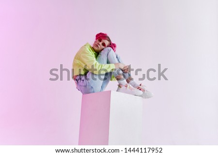 woman sitting on a cube hairstyle retro style studio
