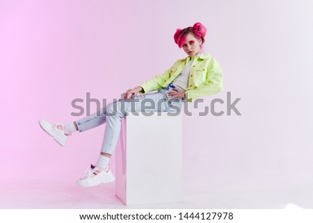 woman with pink hair sits on a cube retro style