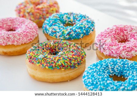 Donuts assortment. Pastel decoration donuts on white table. Closeup view