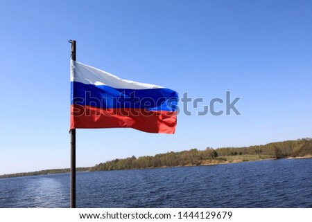 View of waving Russian flag on background of Volga river