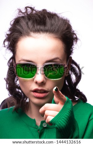 beautiful girl in green glasses and green sweater
