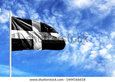 National flag of St Piran on a flagpole in front of blue sky