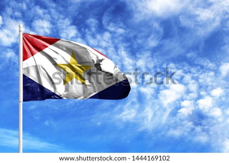 National flag of Saba on a flagpole in front of blue sky