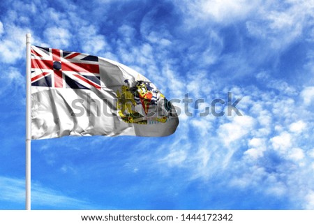 National flag of British Antarctic Territory on a flagpole in front of blue sky