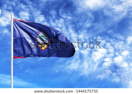 National flag of Guam on a flagpole in front of blue sky