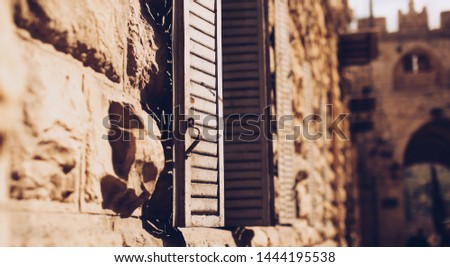 Close up of window hatch along an ancient wall in Jerusalem.