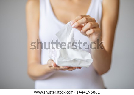 Wet wipes are universal an practical: woman take one wipe from big package for cleaning Royalty-Free Stock Photo #1444196861