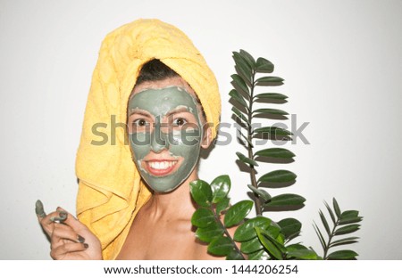 spa background woman in a towel on her head in a skin care cosmetic mask