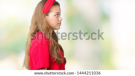 Young beautiful brunette woman wearing red t-shirt over isolated background looking to side, relax profile pose with natural face with confident smile.