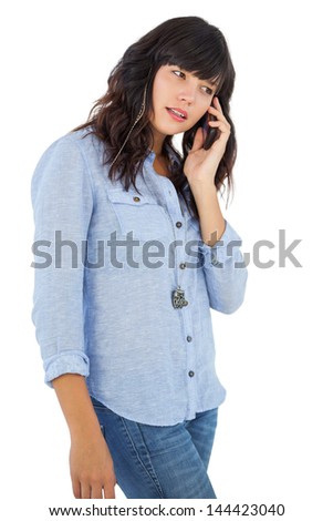 Brunette with her mobile phone calling someone on white background