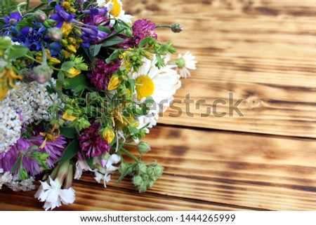 bouquet of wild flowers on wooden background