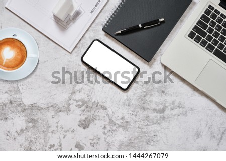 Flat lay, Concept architects or engineer modern desk in the office with laptop, notebook, smartphone white screen, pen, coffee and model house blueprint. copy space for your text or graphic.
