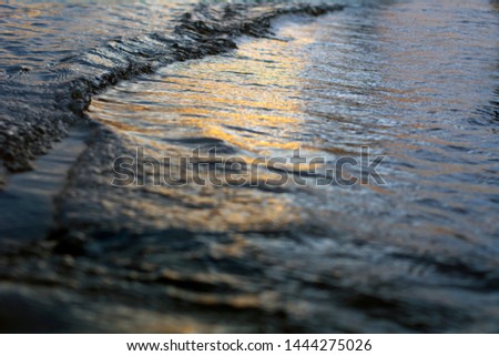 Close-up photos of water waves in the evening